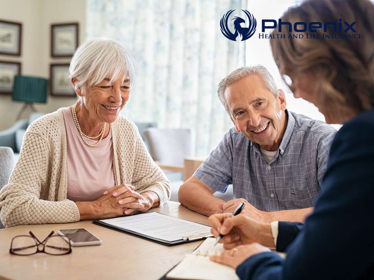 Elderly couple smiling while discussing Healthcare & Insurance with an agent
